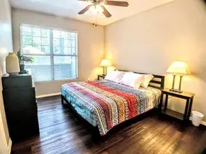 Furnished living room with sofa, coffee table, and flat-screen TV in a Canyon Apartments unit