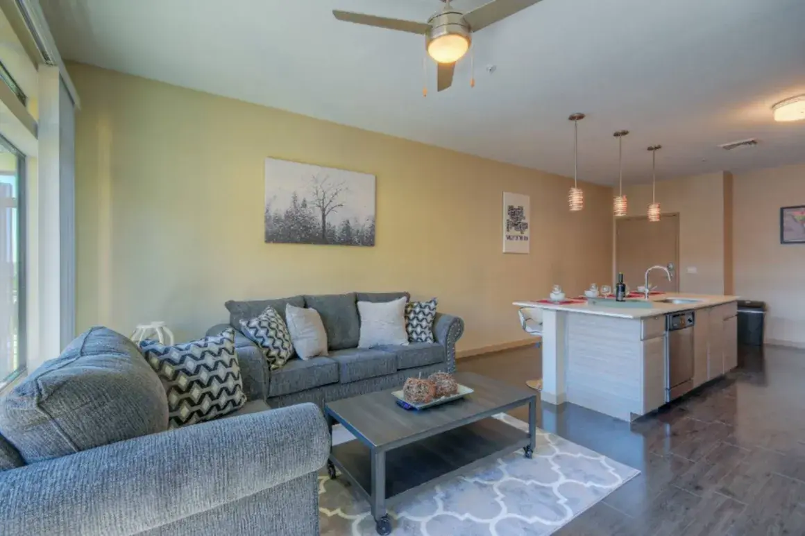 Spacious furnished living area with sectional sofa and entertainment setup