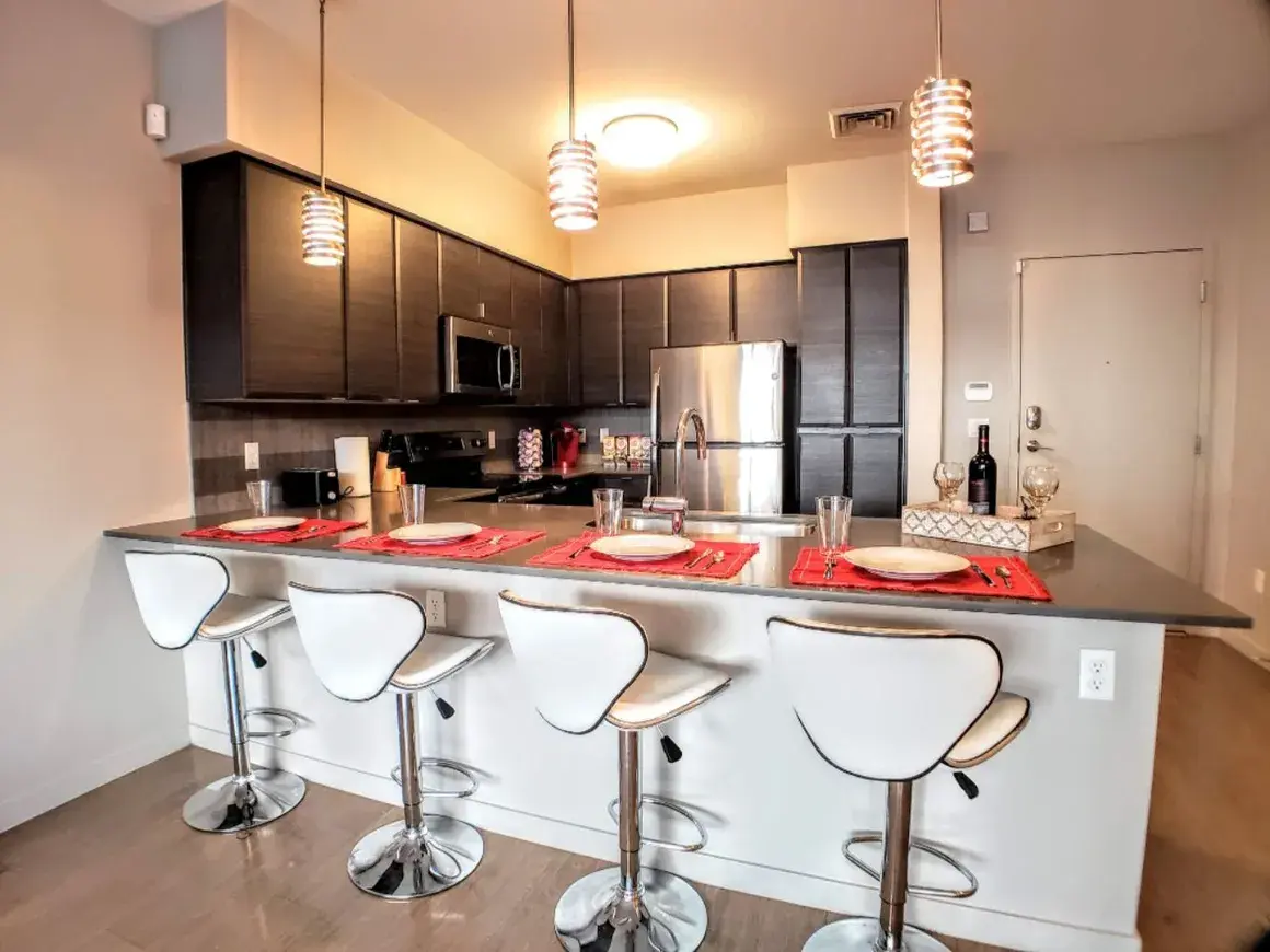 Furnished primary bedroom in a Canyon Apartments extended-stay unit