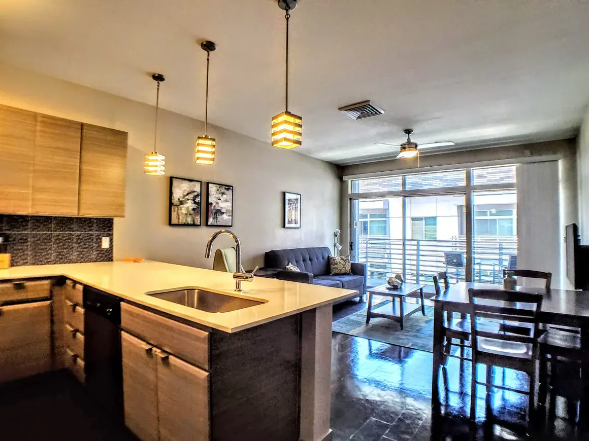 Furnished living room with TV and couch in a corporate housing unit